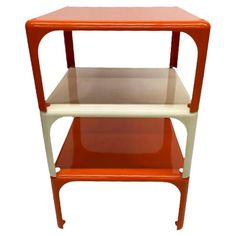 an orange and white shelf with two shelves