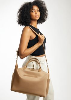 Here by popular demand - she’s one of our most requested designs. She’s more than a tote, more than a diaper bag, and she is now available in our “just-right” midi size. Emmy Midi is a one of a kind everyday staple. By bringing together Nappa leather elements with our signature luxe nylon, you can spice up your everyday look while still keeping it casual. We are big on versatility, which is why we’ve made a tote that opens extra wide and has internal compartments. She converts from a shoulder ba Midi Size, Everyday Purse, Work Bag, Backpack Straps, Changing Pad, Black Hardware, Nappa Leather, Spice Up, Laptop Sleeves