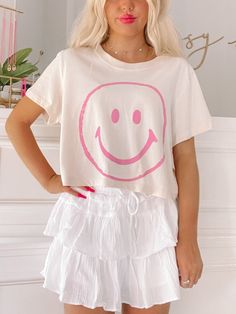 Add a smile to your wardrobe with the Simply Smiley Tee from Sassy Shortcake - This neutral cropped tee puts a pink smiley face front and center. She is paired here with our flirtatious white linen skirt. fit: true to size, model wearing a size small. care: hand wash cold Preppy Shirts For School, Cute Preppy Clothes, Preppy Back To School Outfits, Preppy Shirts, Sassy Shortcake, Pink Smiley Face, Preppy Wardrobe, White Linen Skirt, Pink Smiley