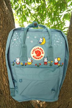 Welcome to our charming collection of hand-embroidered Fjallraven Kanken backpacks, meticulously crafted with love and precision. Elevate your style and stay organized on-the-go with these premium quality backpacks available in two convenient sizes:  - Medium (27x38x13cm)  - Large (32x42x13cm) + Key Features: - Hand-Embroidered Excellence: Each Fjallraven Kanken backpack is adorned with exquisite hand-embroidery, creating a unique and exclusive piece that sets you apart from the crowd. - Premium Miffy Backpack, Grey Jansport Backpack, Kanken Totepack, Embroidered Kanken, Backpack Kanken, Kanken Embroidery, Backpack Embroidery, Miffy Bunny, Backpack Ideas