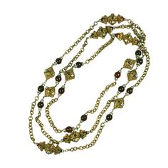 Chanel's signature baroque, gilt metal filigree, ruby pate de verre and crystal rondelle sautoir necklace from 1950's. A staple of the Chanel language, produced by Robert Goossens and worn with Chanel's classic suits or evening clothes. Unsigned. 1950's France. Excellent condition. Clasp in back allows chain to be wrapped several times. Length 68", Width .75" at widest point Evening Clothes, Classic Suits, Gold Link Necklace, Rings Luxury, Chanel Chanel, Gold Diamond Necklace, White Gold Necklaces, Yellow Gold Chain, Hanging Pendants