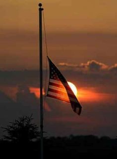 an american flag flying in the wind with text that reads, today we remember the victims