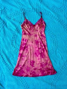 Expertly hand dyed nylon vintage slip dress. Layer this look over a turtle neck in the winter or over a swimsuit by the pool, they're great on their own too! This vintage slip has been carefully tie dyed to disguise stains and discoloration. Originally white, it has a unique all over tie dye pattern in bright pink. Can be washed on cold with like colors. This is a one of one item This slip is in very good vintage condition. There are no holes or tears. The straps are adjustable. Bust: 44" Waist: Fitted Pink Slip Dress For The Beach, Bohemian Fitted Dress For Loungewear, Fitted Bohemian Dresses For Loungewear, Vintage Fitted Slip Dress For Summer, Hand Dyed Fitted Summer Dress, Vintage Pink Slip Dress For Summer, Vintage Slip Dress, Dress Layer, Vintage Slip