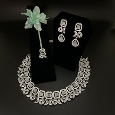 Indian, Pakistani jewelry. A glamorous necklace set with maang tikka, premium quality AD and cubic zirconia, perfect for all occasions. Hand Set Diamond Sets For Gift, Hand-set Cubic Zirconia Party Sets, Elegant Festive Tikka With Cubic Zirconia, Elegant Party Tikka With Hand Set Details, Elegant Festive Cubic Zirconia Tikka, Festive Cubic Zirconia Jewelry For Reception, Festive Dazzling Cubic Zirconia Jewelry, Dazzling Kundan Necklace With Cubic Zirconia For Formal Occasions, Silver Kundan Necklace With Elegant Cubic Zirconia Design