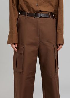 Color: BrownLightweight cotton fabricRelaxed cargo styleEnlarged cargo pockets at each legSlant hip pocketsAdjustable toggles at hemHook and bar closureZip flyUnlined100% CottonDry CleanBy The Frankie Shop. Imported Brown Parachute Pants With Belt Loops For Fall, Brown Utility Bottoms With Belt Loops, Brown Utility Bottoms With Multiple Pockets, Utility Brown Bottoms With Multiple Pockets, Brown Cotton Cargo Jeans With Belt Loops, Brown Cargo Pants With Cargo Pockets For Fall, Brown Cargo Pants With Pockets For Fall, Brown Fall Cargo Pants With Belt Loops, Brown Cargo-style Parachute Pants