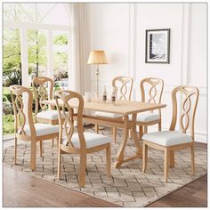 a dining room table with six chairs and a rug