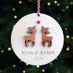 a wooden ornament with two deers on it