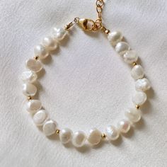 This beachy bracelet is an updated version of a classic. Freshwater nugget pearls Gold beaded accents Length: approx. 8" including extender Handmade in Utah by Katie Waltman Jewelry Home Decor Boutique, Beachy Bracelets, Bracelet Materials, Gold Bead Bracelets, Summer Season, Gold Beads, Pearl Bracelet, Style Design, Fresh Water