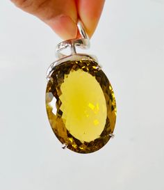 The pendant features a  large natural earth-mined 121.15 CTS Super Quality AAA Unheated Citrine.   A big bold sparkle yellow gemstone has been hand crafted in 92.5 Sterling Silver with UK hallmark in a swirling design.  A basket setting pendant with smooth and polish silver. Only 1 is available Clarity  - Transparent Type     - Natural Citrine Colour - Brilliant Yellow Citrine size                    : 40 mm  Length * 30mm Width * 16 mm Depth, 121.15 carats   Total pendant size       : 60.5 mm Transparent Art, Basket Setting, Yellow Gemstones, Natural High, Yellow Citrine, Natural Citrine, Polish Silver, Natural Earth, Christmas Sale