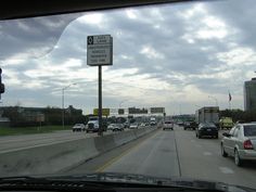 cars driving down the highway on a cloudy day