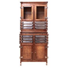 an old wooden cabinet with glass doors on the front and bottom shelves, against a white background