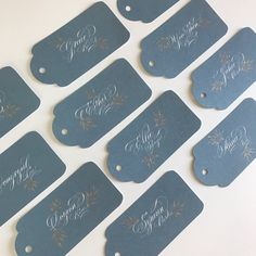 six blue tags with gold lettering on them