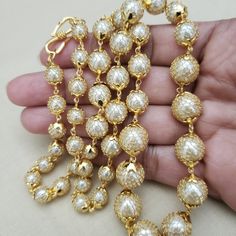 Handmade with Semi precious pearl from India. Beautiful round shape accented with gold filled net on pearl beads. Finished with a gold plated chain and clasp. Length of necklace: 24 inches A BLEND OF TREND AND TRADITION' Comes in a gift box and free shipping in the US. Festive Gold Plated Pearl Chain Necklace, Pearl Chain Necklace With Round Beads, Gold Plated Pearl Chain Necklace For Celebrations, Gold Single Strand Beaded Necklace For Party, Gold Pearl Chain Necklaces For Festive Occasions, Gold Pearl Necklace With Polished Beads For Party, Gold Beaded Pearl Necklace For Formal Occasions, Elegant Gold Chain Necklace With Polished Beads, Festive Gold Necklaces With Pearl Chain