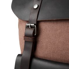 a brown and black backpack with leather straps