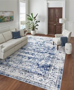 a living room filled with furniture and a blue rug