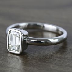 a close up of a diamond ring on a table