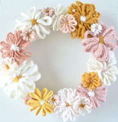 a close up of a wreath made with crochet flowers