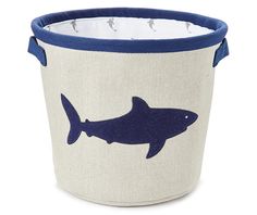 a blue and white basket with a shark on it