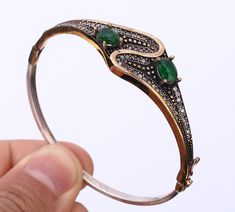 TURKISH SIMULATED EMERALD .925 SILVER & BRONZE BANGLE BRACELET #35547 Material is .925 Solid Sterling Silver and Bronze. The stones are EMERALD. This Bangle Bracelet is 19,16 grams. Width is 0,74". Inner diamater is 2.53". All our silver items have the 925 stamp. ***All our items are made in EUROPE with high quality workmanship*** Visit our other auctions for great deals PLEASE READ: Your satisfaction is our priority. 100% Satisfaction Guarantee. Returns are accepted within 14 days after item de Elegant Bronze Bangle Bracelet, Formal Bronze Bangle Jewelry, Elegant Bronze Bangle Jewelry, Elegant Bronze Bangle, Antique Stamped 925 Silver Bangle, Green Brass Bracelet Jewelry, Green Brass Bracelet, Green Stone Setting Bracelet Jewelry, Hallmarked Brass Bangle Jewelry