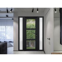 a black and white photo of a living room with an open door to the outside