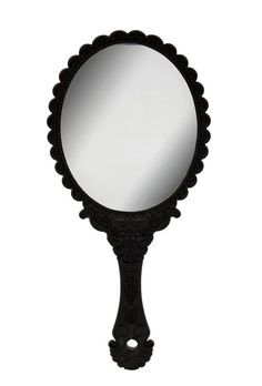 an ornate black mirror on a white background