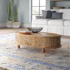 a living room with a couch, coffee table and rug