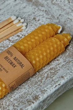 three corn on the cob sticks are sitting next to each other, with matches in them