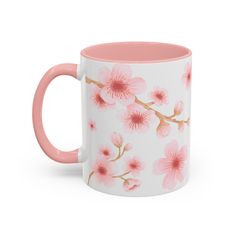 a pink and white coffee mug with flowers on the inside, sitting in front of a white background