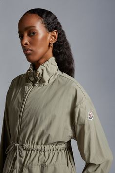 Utilitarian at its core, the Iadi parka is crafted from nylon poplin. The parka jacket is enhanced with breathable mesh lining and practical patch pockets.  Designed with supreme wearability in mind, drawstring fastening on the waist adapts the jacket's silhouette to fit your body and mood. Featured in a neutral colorway, the parka jacket is easy to wear every day. Green Nylon Utility Parka, Khaki Nylon Parka With Detachable Hood, Khaki Nylon Utility Windbreaker, Utility Nylon Khaki Windbreaker, Utility Style Khaki Nylon Windbreaker, Khaki Nylon Windbreaker With Detachable Hood, Nylon Utility Parka With Cargo Pockets, Utility Nylon Parka With Cargo Pockets, Functional Nylon Parka With Cargo Pockets