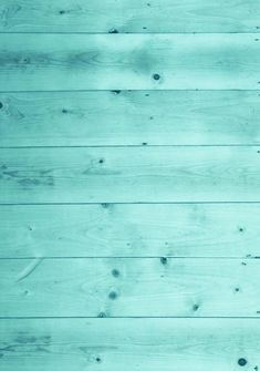 an image of wood planks that are very light blue and green in the background