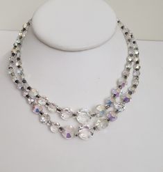 "Unique double stranded crystal rhinestone necklace or choker fit for a princess. The saucer shaped crystals are clear on one side and aurora borealis on the other, making it sparkle like diamonds. The crystals are graduated in size along each of the two strands.  The hook closure adjusts from 12 to 14 1/2\". The beads range from 1/4\" to 5/8\".  In good vintage condition. Previously owned. There is some wear to the aurora borealis finish on some crystals. No noted damage otherwise. Please see the photos as they are part of the description.  Please do browse our other items as we do combine shipping for savings." White Crystal Rhinestone Necklace In Costume Jewelry Style, White Crystal Rhinestone Costume Necklace, Crystal Necklaces With Round Beads For Anniversary, Anniversary Crystal Necklaces With Round Beads, Anniversary Necklace With Crystal Round Beads, Crystal Necklaces With Faceted Beads For Wedding, Clear Crystal Necklaces For Wedding, Adjustable Clear Crystal Necklaces, Adjustable Crystal Necklaces For Formal Occasions