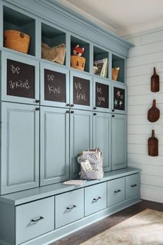 a room with blue cabinets and chalkboard on the wall