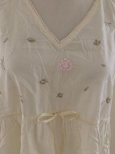 Beautiful 100% cotton vintage Laura Ashley nightgown!  Tagged XL Pale yellow with embroidered bodice and drawstring tie below bust. 3 inch ruffle at the bottom. Soft and cool. Made in India Bust flat pit to pit is 23 inches Underbust at about drawstring is 20 inches 38 inches long No issues! Vintage used garment. Beautiful! Final sale. Please ask questions!  No returns. Sold as is. 💐💐 Floral Embroidered Summer Nightgown For Daywear, Summer Floral Embroidered Nightgown For Daywear, Floral Embroidery Nightgown For Summer Daywear, Floral Embroidered Nightgown For Summer Daywear, Floral Embroidered Nightgown For Daywear In Summer, Cotton Beach Nightgown With Ruffles, Beach Nightgown With Ruffles In Cotton, Sleeveless Cotton Vintage Nightgown, Feminine Cream Sleeveless Nightgown