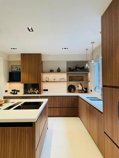 a kitchen with wooden cabinets and white counter tops