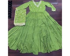 Exclusive Green Anarkali Gown Full Flair gown 12 mtr Flair Indian Long Gown 5 frill Gown Anarkali suit Party wear gown Readymade Gown  GOWN-WITH-DUPATTA  GOWN   :-  FABRICS & WORK    :- Unique Coloured Faux Georgette with Embroidered work SIZE         :- M(38"), L(40"), XL(42"), XXL(44") LENGTH   :- 56 INCH FLAIR       :- 12 MTR  LINING     :- Cotton  (Full Inner Top To Bottom) SLEEVES    :- Full Sleeves NECK TYPE    :- Designer V Neck STITCHING TYPE :- 5 Layer Frill Stitching DUPATTA :- FABRIC Fitted Pista Green Anarkali Set Maxi Length, Traditional Pista Green Maxi Dress, Green Floor-length Maxi Dress For Eid, Green Long Sleeve Gown For Diwali, Pista Green Maxi Dress For Designer Wear, Designer Pista Green Maxi Dress, Eid Green Floor-length Maxi Dress, Pista Green Anarkali Maxi Dress, Pista Green Designer Maxi Dress