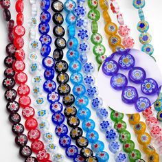 multicolored glass bead necklaces with flower designs on them and a white disc in the middle