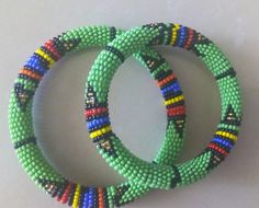 Beaded Bracelets | African Maasai Beaded Bracelets | African Jewelry | Zulu Beaded Bracelets | Ethnic Bracelets | Gift For Her | A Set Of Two These superbly crafted Zulu beaded bracelets are made of fine beads.The price is for a set of two bracelets.Main Color - Green.Size - Standard measurement is 7 - 8 inches.For smaller or larger bracelets please contact me.Available in different colors.Feel free to send me a convo or e-mail for any clarification.Thank you for visiting... Traditional Round Beaded Bracelets For Festival, Artisan Green Bracelets For Festival, Artisan Green Bracelet For Festivals, Traditional Hand Wrapped Beaded Bracelets, Bohemian Beaded Bangle For Festivals, Traditional Adjustable Bangle With Colorful Beads, Bohemian Handmade Bangle With Round Beads, Bohemian Beaded Festival Bangle, Handmade Bohemian Bangle With Round Beads