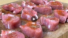 raw meat on a wooden cutting board with seasoning