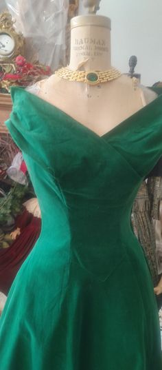 Stunning velvet 1950 dress. good condition.   dark green.  portiat neckline.  beautifully made.  collar has shoulder freature with the tip of collar raised upward to flatter shoulders.   slight flair to skirt.  ptincess styling.  Back has velvet flap over.  size 5-7.   very good condition.  necklass not included.   no refunds Dark Green Fitted Dress For Formal Occasions, Dark Green Fitted Formal Dress, Elegant Fitted Green Velvet Dress, Fitted Green Velvet Dress, Green Velvet Dress For Formal Occasions, Green Holiday Dress, 1950 Dress, Dark Green Velvet, Princess Jewelry