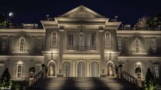 a large white house lit up at night