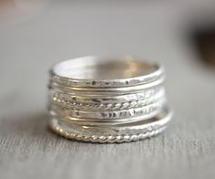 Beautiful mix of .925 sterling silver stacking rings. Slim stackable rings. Set of 8. Also available in 14k yellow and rose gold filled. 2 smooth bands, 2 hammered bands, 2 twist bands, and 2 faceted bands If you don't see your size please feel free to message me. All orders ship in a gift box. If you are ordering multiple items and want them boxed separately, please let me know in the notes at checkout. I ship via USPS. Please review the estimated delivery date and processing times. Processing Rings Simple Silver, Twisted Band Ring, Gold Amethyst Ring, Ring Spacer, Stackable Rings Silver, Rose Gold Quartz, Sterling Silver Stacking Rings, Stacking Ring Set, Quartz Crystal Necklace