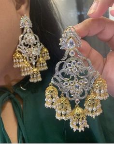 A beautiful pair which highlights the regal traditions and beyond! Beautifully handcrafted dangler style earrings encrusted with navratan and zircon stones. Approximate earrings length is 3.2�″ Wedding Chandbali Bridal Earrings With Jewels, Wedding Bridal Chandbali Earrings With Jewels, Silver Chandbalis With Intricate Design For Reception, Silver Jhumkas With Stone Work For Reception, Silver Chandbalis With Stone Work For Reception, Traditional Silver Jhumkas For Reception, Temple Jewelry Stone Work Danglers For Celebration, Temple Jewelry Danglers With Stone Work For Celebration, White Danglers With Intricate Design For Reception