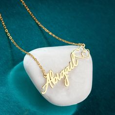 "Personalized Name Necklace With Heart, Custom Name Jewelry, Sterling Silver Name Necklace, Handmade Name Necklace, valentine's day gift TO OUR VALUED CUSTOMERS ! Please take a look at our special catalog that we have prepared for you !  ▶ https://www.etsy.com/shop/DaintyMark D E T A I L S * Made to Order. * Handmade with Sterling %100 925K Sterling Solid Silver. * Choice of Gold Color: Gold, Rose Gold, Silver * Length: 14\", 16\", 18\", 20\", 22\"  * Ready to Ship in 1-3 Business Days * Free returns within 14 days from the order date. A B O U T ∙ U S * All personalization is done by hand. Because it's better that way. * 100% Ethically Sourced raw materials. * Our lovely packaging is made with love and passion. * Handcrafted by our trusted craftsmen with care. G I F T ∙ T I M E We love gif Name Heart Pendant Necklaces For Anniversary Gift, Heart Cut Name Necklace For Valentine's Day, Name Engraved Heart Pendant Necklace For Anniversary, Customizable Heart Necklaces For Anniversary, Customizable Pendant Name Necklace For Valentine's Day, Customizable Heart Pendant Necklaces For Valentine's Day, Handmade Heart Jewelry For Valentine's Day, Handmade Heart-shaped Jewelry For Valentine's Day, Valentine's Day Heart Cut Name Necklace