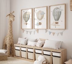 three framed pictures hang on the wall above a bench in a child's room