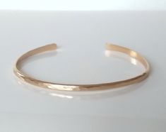 Beautiful delicate and dainty, this 14k gold filled hammered cuff bracelet is a great everyday accessory. Once placed around your wrist, you can gently squeeze your bracelet to accommodate your wrist size. These cuffs are giving and somewhat flexible, but please do treat it with loving care. This cuff is 2 mm in width. You may select from small, medium or large in the SIZE drop down menu. Custom Engraved Necklace, Hammered Cuff Bracelet, Jewelry Layering, Dainty Gold Bracelet, Gold Cuff Bracelet, Bar Necklace Personalized, Silver Bar Necklace, Wide Cuff Bracelets, Bracelet Minimalist