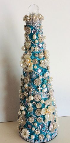 a blue and white christmas tree with pearls