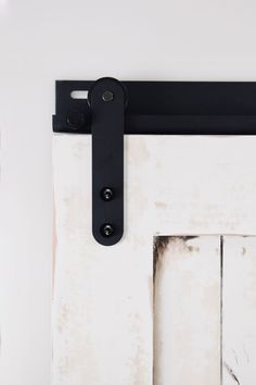 an old white door with a black handle on it