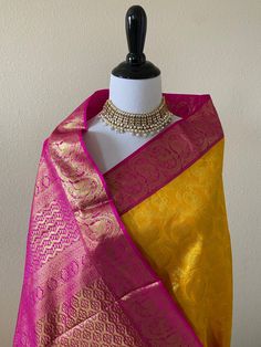 ShopNaya brings you the finest handloom silk from Kanchipuram, southern part of India, known for their highly skilled weavers and rich cultural heritage. Sunny yellow handloom pure silk saree. Body of the saree has peacock brocade design with 18in wide pink and gold zari border. Pallu has beautiful floral motifs with pink and gold zari. Blouse color is pink with the same zari border as the saree. ** Falls and pico finished. Blouse is cut and sent as a separate item. Silk mark tag attached. Wash Pure Chiffon Sarees, Indian Bride Outfits, Fancy Sarees Party Wear, Indian Saree Blouses Designs, Simple Sarees, Saree Silk, Pink Bride, Yellow Saree, Pure Chiffon