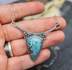 This pendant features a vivid blue shattukite stone, I just love the vibrant blue coloration it has. Shattukite is found in Bisbee Arizona and is relatively rare, it gets its blue color from the copper in it. I think what I like best about this stone is it dispels bad energies while looking so pretty. Flip the pendant over and I have textured the metal with a pattern that mimics the pattern in the stone. The details on this pendant were all carefully thought out to create a true statement piece Blue Turquoise Necklace With Large Teardrop Stone, Unique Blue Teardrop Turquoise Necklace, Blue Teardrop Necklace With Large Stone, Artisan Blue Necklace With Large Stone, Blue Chrysocolla Necklace With Large Stone, Blue Chrysocolla Jewelry With Natural Stones, Blue Chrysocolla Pendant Jewelry, Blue Chrysocolla Pendant Necklace, Chrysocolla Turquoise Necklace Gift