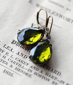 Harlow  Lovely Vintage German faceted crystal jewels, in a gorgeous Olive green colour, foiled on the back for extra sparkle and set in new antiqued brass settings and French levered ear wires. Crystals circa 1940's These vintage earrings a extremely versatile, great for the office and perfect for nights out. They measure 18mm x 13mm Green Teardrop Jewelry For Evening, Antique Green Jewelry For Evening, Green Brass Jewelry For Party, Vintage Green Evening Jewelry, Victorian Green Earrings For Wedding, Green Jeweled Teardrop Jewelry, Elegant Green Brass Jewelry, Green Faceted Jewelry For Weddings, Green Faceted Earrings For Wedding